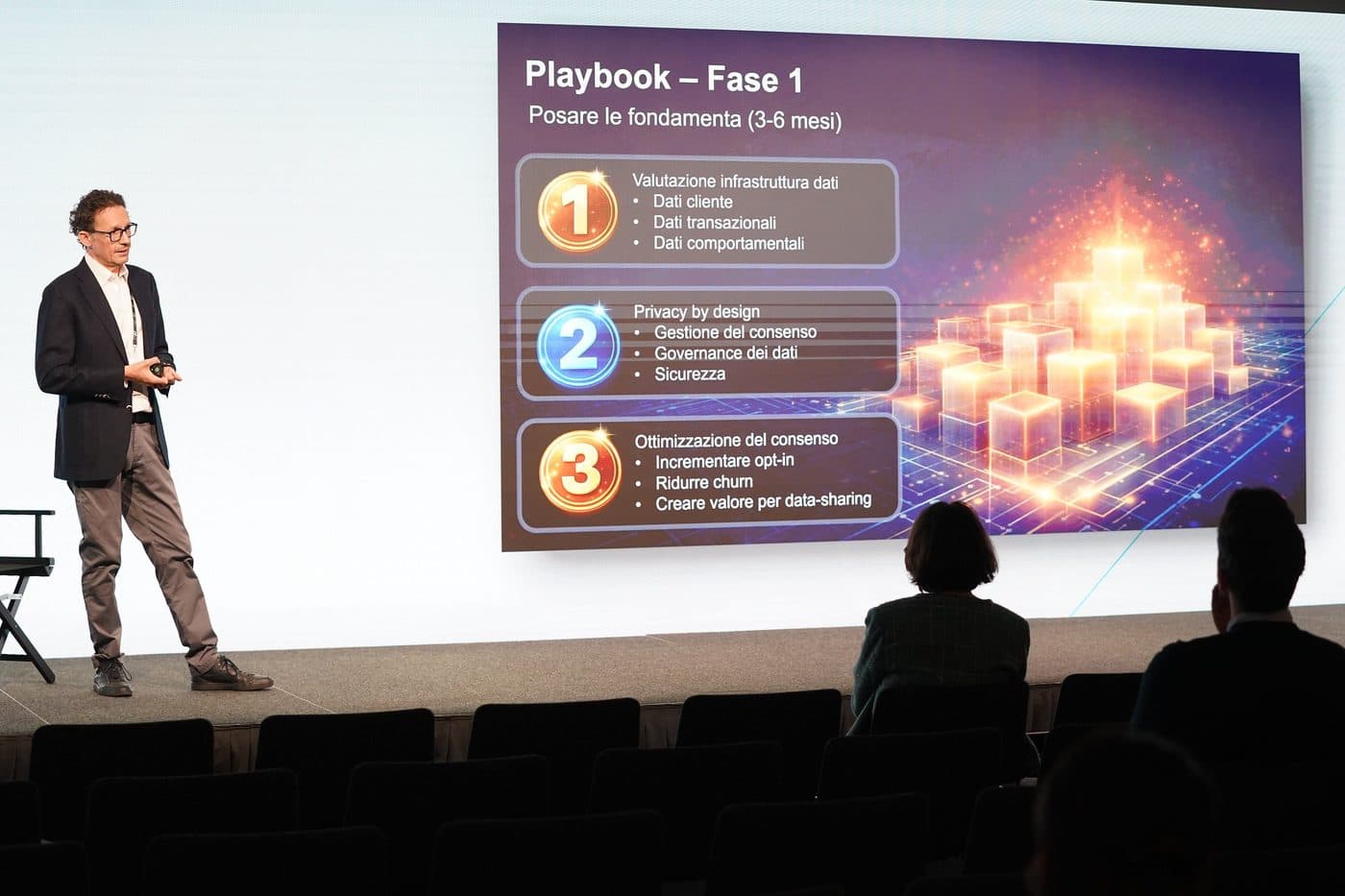 Gianluca Carrera on stage beside a slide setting out a data monetisation playbook